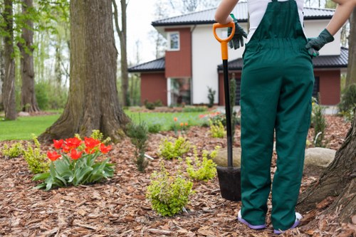 Gardener wearing full PPE working on a maintained lawn